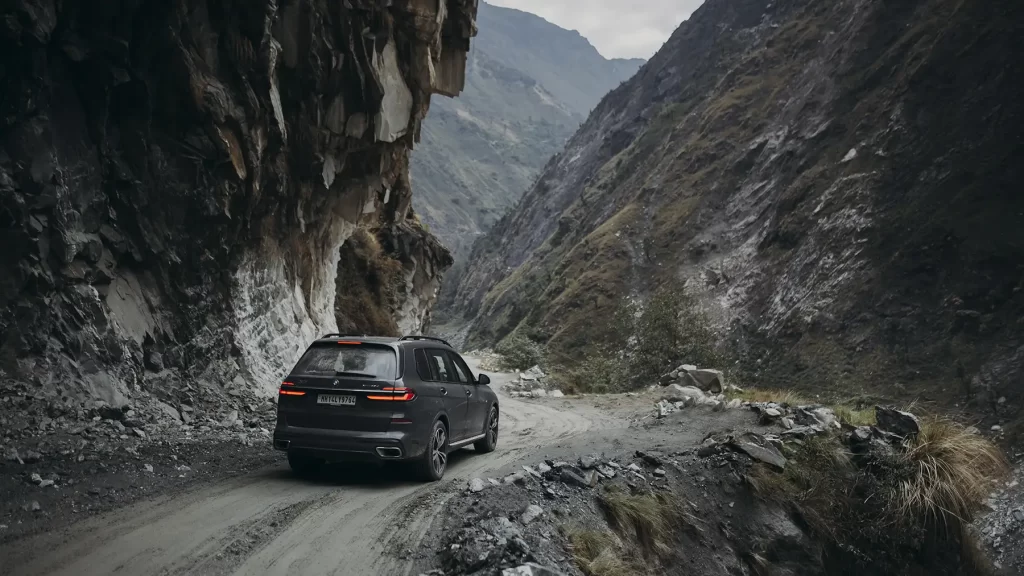 Automotive photography of a car navigating tough roads en route to Adi Kailash and Om Parvat.