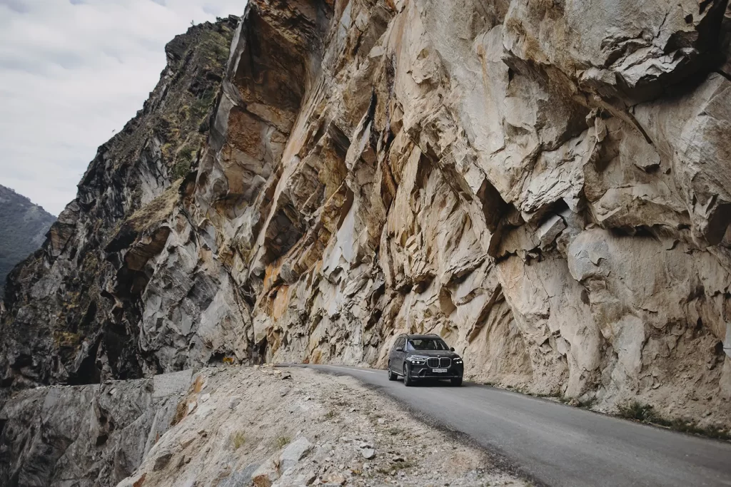 Automotive photography of a car navigating tough roads en route to Adi Kailash and Om Parvat.