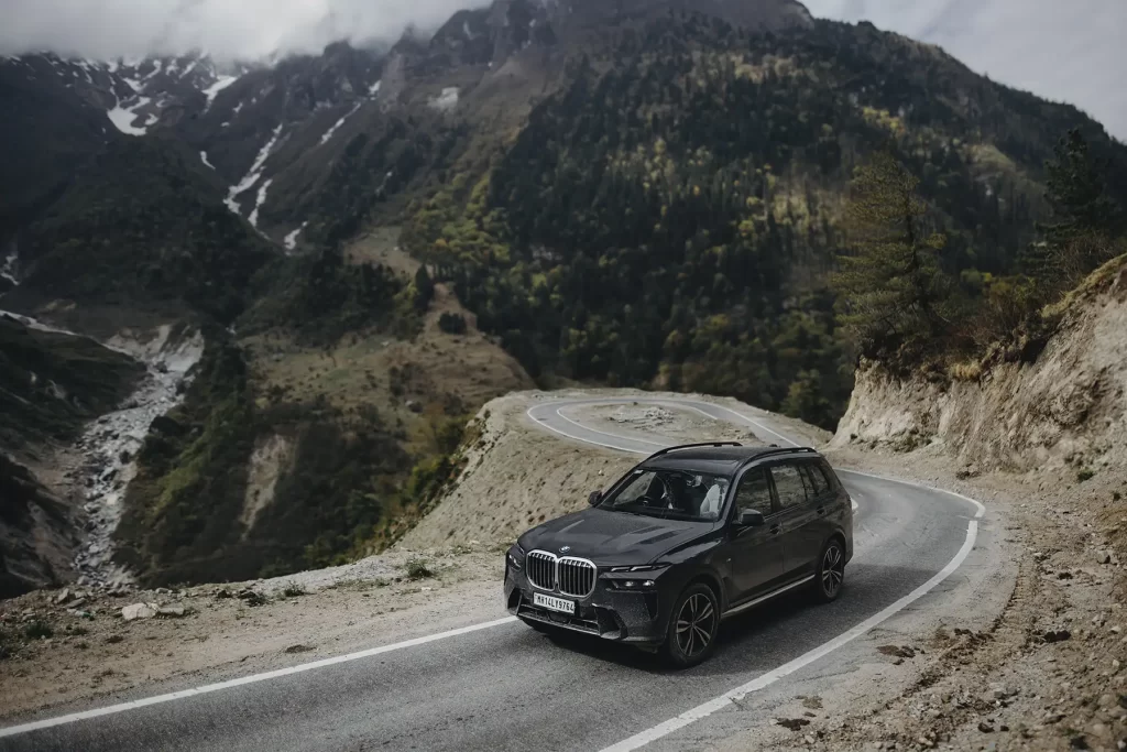 Automotive photography of a car navigating tough roads en route to Adi Kailash and Om Parvat.